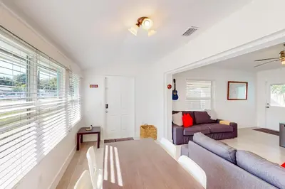 a living room with a couch and a table at Palm Shadow Sanctuary in Fort Lauderdale