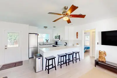 a kitchen with white walls and a ceiling fan at Palm Shadow Sanctuary in Fort Lauderdale