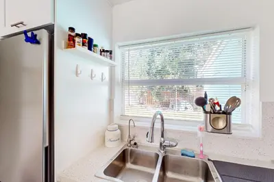 a kitchen with a sink and a window at Palm Shadow Sanctuary in Fort Lauderdale