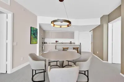 a kitchen and dining room with a table and chairs at Beachfront Escape Pool Gym Stunning Views 30th floor in Hallandale Beach