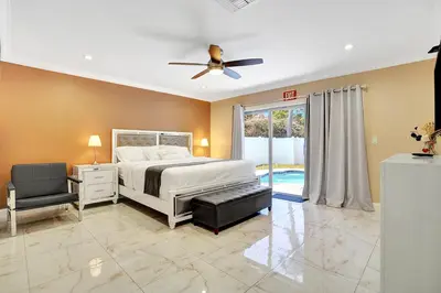 a bedroom with a bed and a ceiling fan at Luxury 4BR & 4BA Villa Heated Pool Minutes To Beach in Hollywood