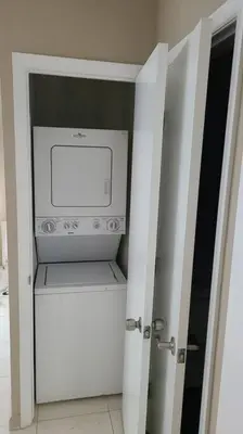 an open door to a kitchen with a microwave at Stylish Home close to everything in Hollywood