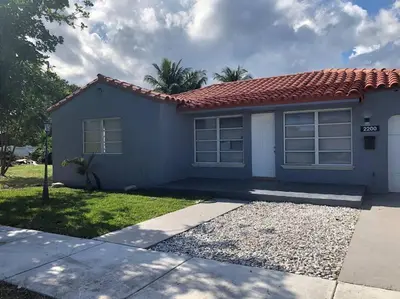 a small blue house with a red roof at Stylish Home close to everything in Hollywood