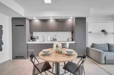 a kitchen and dining room with a table and chairs at Breathtaking studio in the Heart Miami in Miami