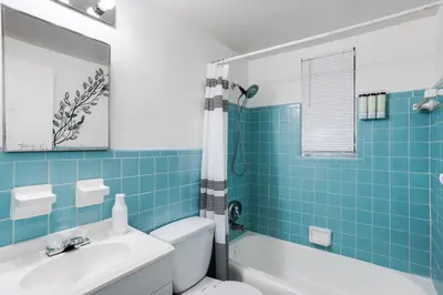 a bathroom with a toilet and a tub and a sink at Little Havana 1BR Apt w Parking in Miami