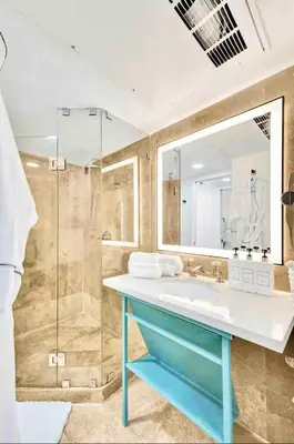 a bathroom with a sink and a shower at Park Place South of Fifth in Miami Beach