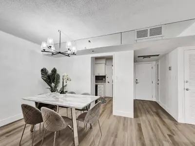 a dining room with a table and chairs at Huge 2BD Miami beach with beach service -720 in Miami Beach