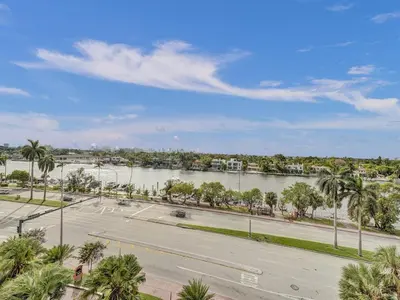 an empty parking lot next to a river with palm trees at Huge 2BD Miami beach with beach service -720 in Miami Beach