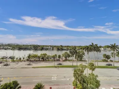 a view of a parking lot with a river and palm trees at Huge 2BD Miami beach with beach service -720 in Miami Beach