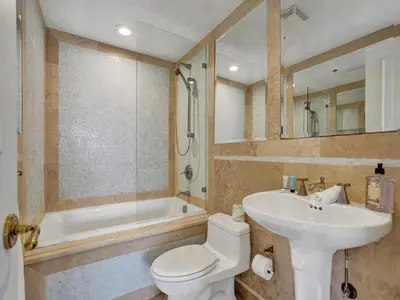 a bathroom with a toilet and a sink and a tub at Ocean Front Penthouse 2BD 2 Balconies PH-2 in Miami Beach