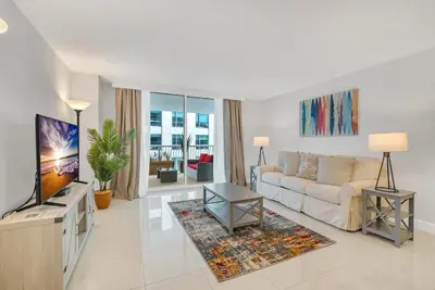 a living room with a couch and a tv at myClub at Brickell Bay in Miami