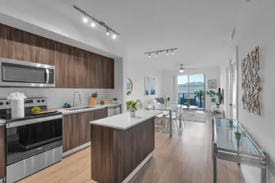 a kitchen with wooden cabinets and stainless steel appliances at Modern 1 Bedroom In The Heart Of Downtown Doral in Hialeah Gardens