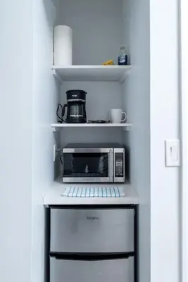 a microwave oven sitting on top of a refrigerator at Bayshore Breeze 2 in Fort Lauderdale