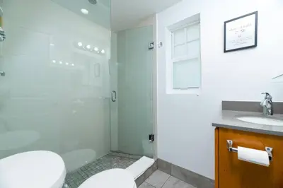 a bathroom with a shower and a toilet and a sink at Bayshore Breeze Free Parking 3 in Fort Lauderdale