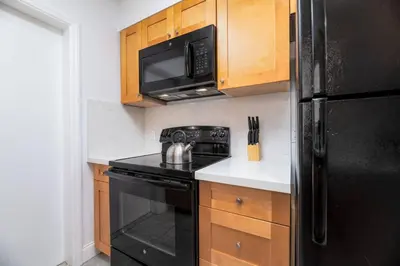 a kitchen with a black stove and a microwave at Bayshore Breeze Free Parking 3 in Fort Lauderdale