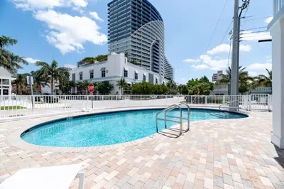 a swimming pool with a building in the background at Bayshore Breeze 4 in Fort Lauderdale