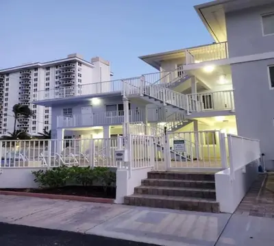 a white house with stairs in front of it at Bayshore Breeze Free Parking 5 in Fort Lauderdale