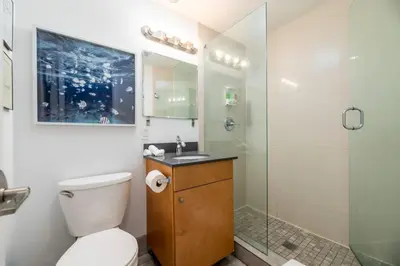 a bathroom with a toilet and a glass shower at Bayshore Breeze 6 in Fort Lauderdale