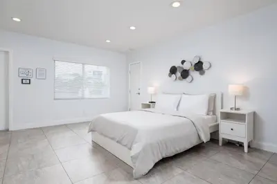 a white bedroom with a large bed and a window at Bayshore Breeze Free Parking 7 in Fort Lauderdale