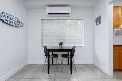 a dining room with a table and two chairs at Bayshore Breeze Free Parking 7 in Fort Lauderdale