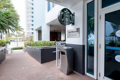 a restaurant with a sign on the side of a building at Bayshore Breeze 8 in Fort Lauderdale