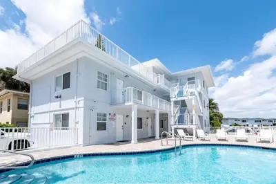 a large white house with a swimming pool at Bayshore Breeze 8 in Fort Lauderdale