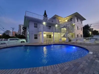 a large swimming pool in front of a house at Bayshore Breeze Free Parking 9 in Fort Lauderdale