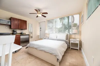 a bedroom with a bed and a ceiling fan at Ocean Breeze Free Parking Apt 1 in Fort Lauderdale