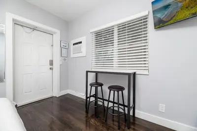 a room with two bar stools and a window at Ocean Breeze Paradise Apt 5A in Fort Lauderdale
