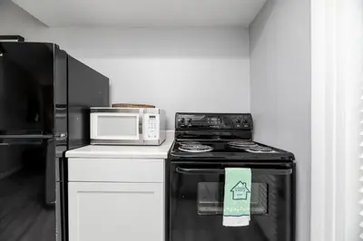 a kitchen with a stove and a microwave at Short Walk to Wilton Drive Apt2 in Fort Lauderdale