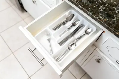 a white drawer with silver utensils in it at Short Walk to Wilton Drive Apt3 in Fort Lauderdale
