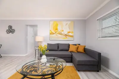 a living room with a couch and a glass table at Short Walk to Wilton Drive Apt4 in Fort Lauderdale