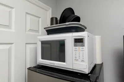 a microwave oven sitting on top of a stove at Short Walk to Wilton Drive Apt5 in Fort Lauderdale