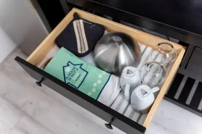 a drawer with a tea pot and other items in it at Short Walk to Wilton Drive Apt5 in Fort Lauderdale