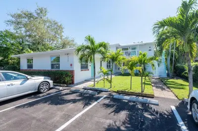 a house with palm trees in a parking lot at Short Walk to Wilton Drive Apt6 in Fort Lauderdale