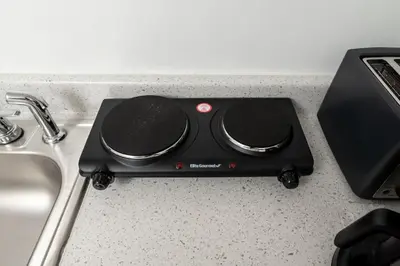 a black appliance sitting on a counter next to a sink at Short Walk to Wilton Drive Apt6 in Fort Lauderdale
