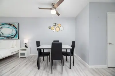 a dining room with a table with chairs and a ceiling fan at Just Off Wilton Drive Apt 2 in Fort Lauderdale