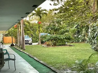 a view of a yard with a car parked in a park at Just Off Wilton Drive Apt 3 in Fort Lauderdale