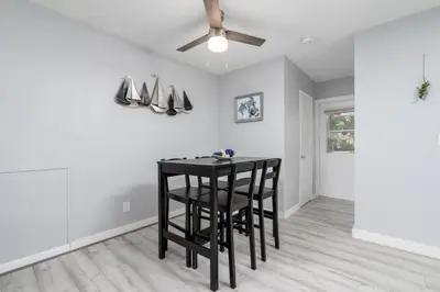 a dining room with a table and a ceiling fan at Just Off Wilton Drive Apt 4 in Fort Lauderdale