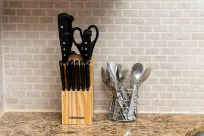 a knife block filled with utensils on top of a counter at Just Off Wilton Drive Apt 5 in Fort Lauderdale