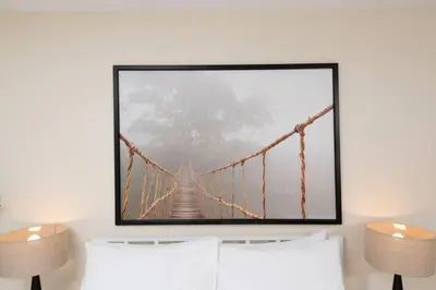 a picture frame hanging on a wall with a suspension bridge at Just Off Wilton Drive Apt 6 in Fort Lauderdale