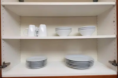 a cupboard with plates and dishes in it at Just Off Wilton Drive Apt 7 in Fort Lauderdale