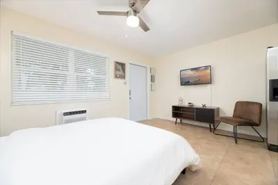 a bedroom with a bed and a chair and a desk at Just Off Wilton Drive Apt 7 in Fort Lauderdale
