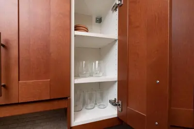 a cupboard with glass vases in it at Just Off Wilton Drive Apt 7 in Fort Lauderdale