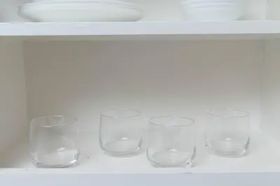 a group of glasses sitting on a shelf at Just Off Wilton Drive Apt 8 in Fort Lauderdale