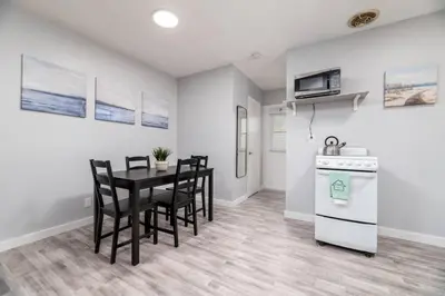 a kitchen with a table and chairs and a stove at Just Off Wilton Drive Apt 8 in Fort Lauderdale