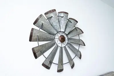 a metal clock on a white wall at Comfy Condos at Middle River Apt 1 in Fort Lauderdale