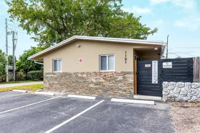 a house with a garage with a black garage door at Comfy Condos at Middle River Apt 2 in Fort Lauderdale