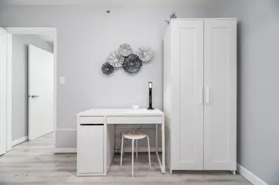 a white room with a desk and a stool at The Dolphin Studio at Lake Ridge in Fort Lauderdale