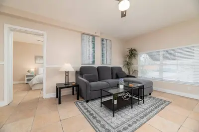 a living room with a couch and a table at The Residences at Lake Ridge Apt 2 in Fort Lauderdale